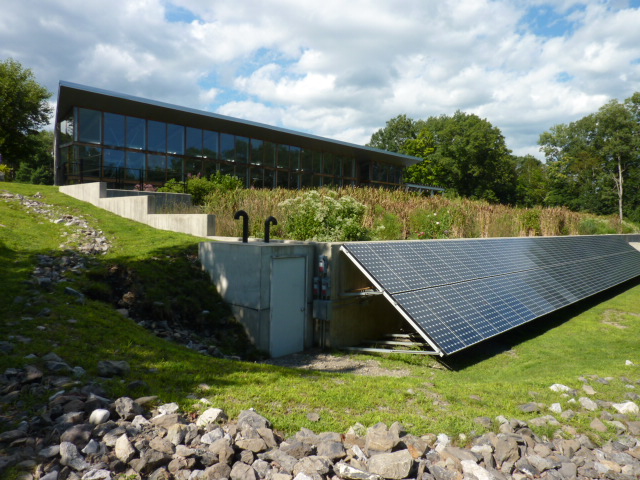 Exterior of Greenhouse with Constructed Wetlands and Solar Panels in Foreground